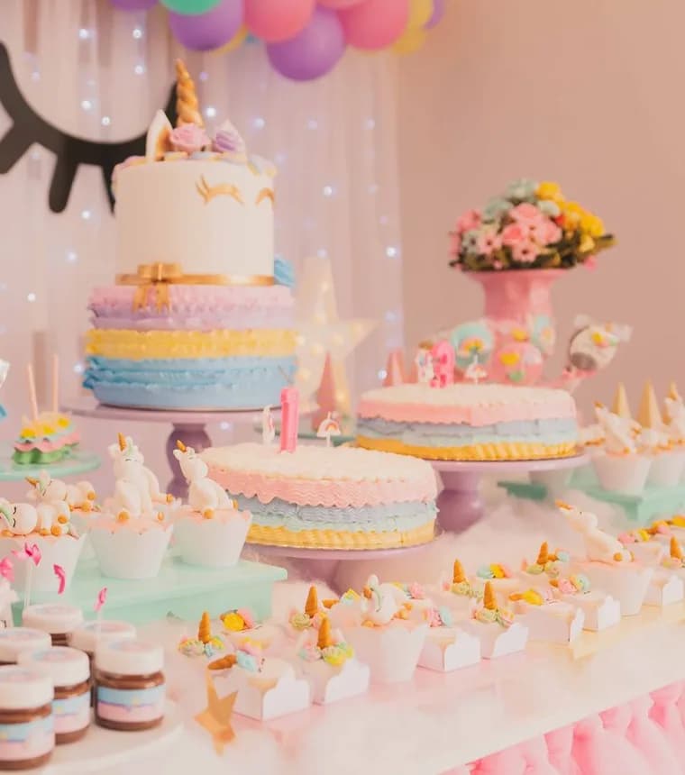 Themed birthday cake designs — tiered and rainbow cakes on a party table
